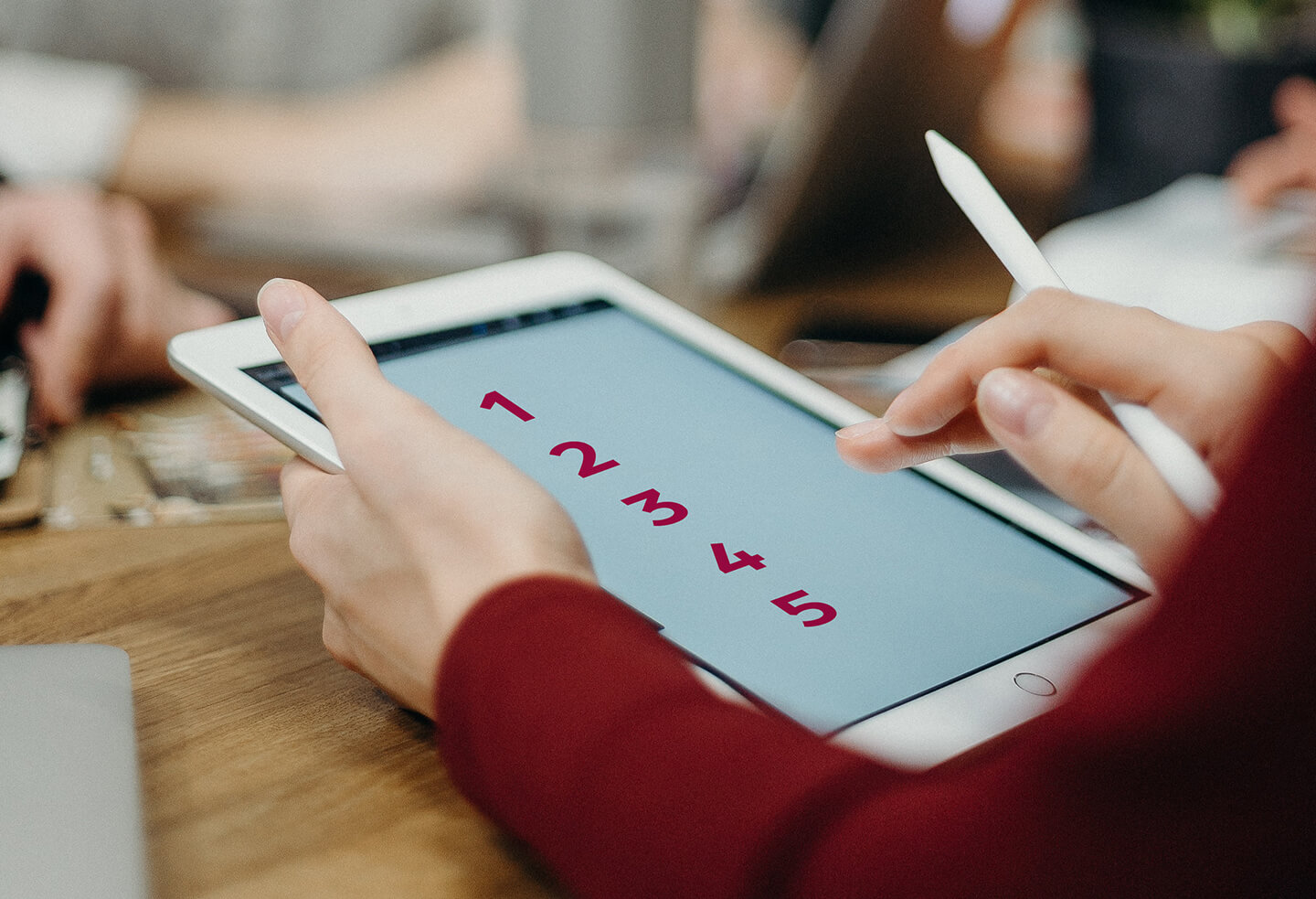 60f556c10e0a405a61792d0a_digi12345 Article Banner Image - A photo of a hand holding a table with numbers 1 to 5 on the screen