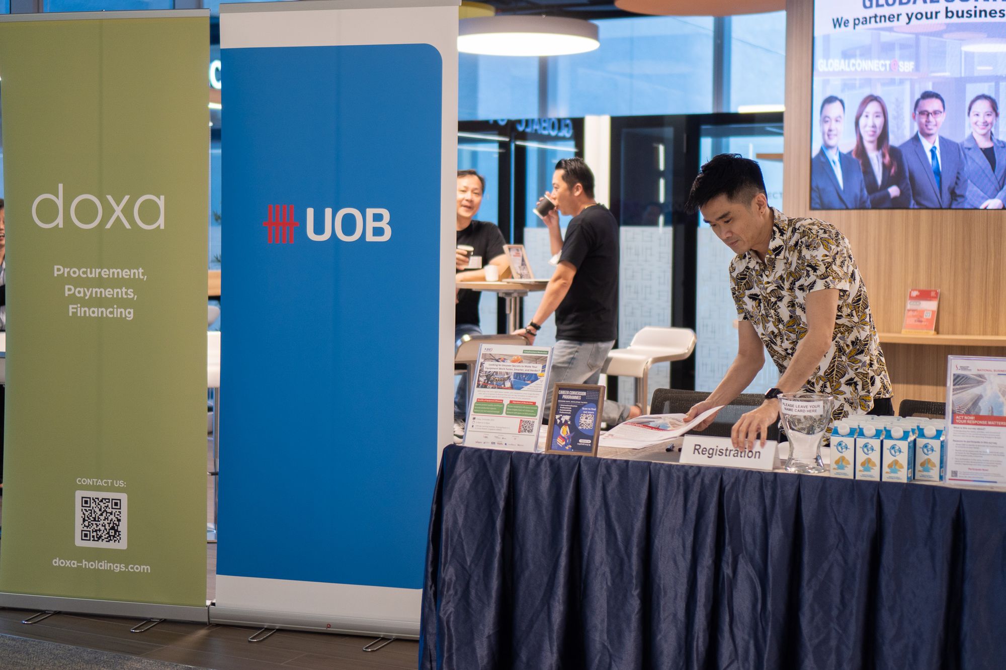 Article Banner Image - A photo of a man organizing his booth on the Doxa Holdings and UOB SBF Seminar